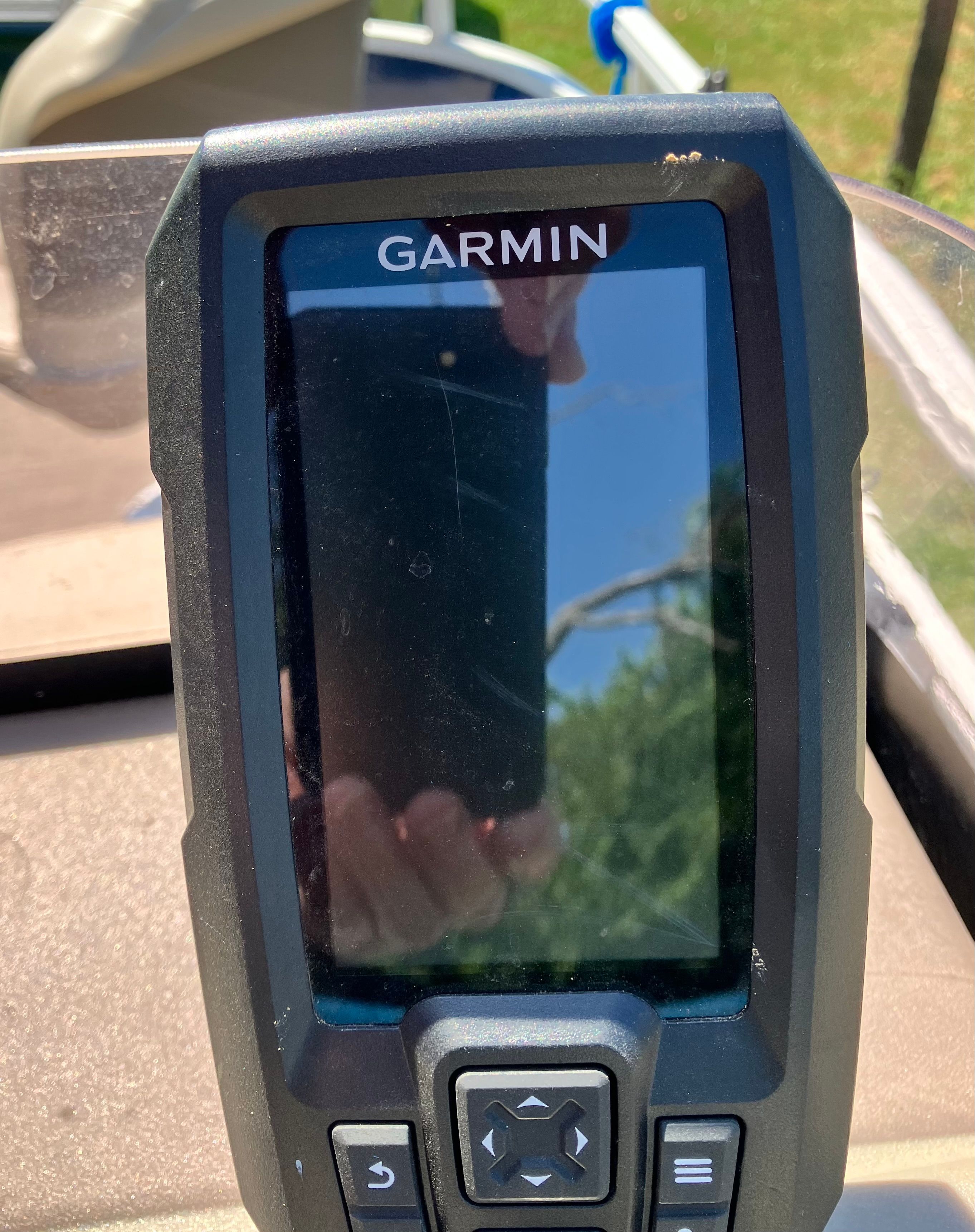 Bass Tracker BB16 Garmin device on 2020 Bass Tracker BB16 boat, reflecting outdoor scenery.