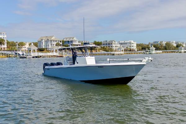 Contender 39 ST 2020 Contender 39 ST boat on calm water near coastal homes.