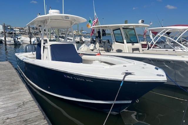 Regulator 26 Forward Seating 2008 Regulator 26 Forward Seating boat docked in marina, blue hull, sunny day.