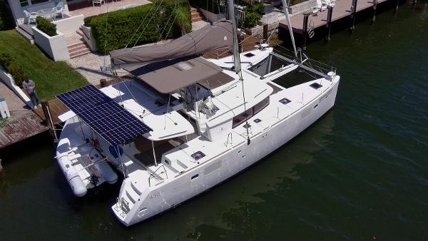 Lagoon 450 F 2016 Lagoon 450 F catamaran docked, featuring solar panels and a spacious deck.