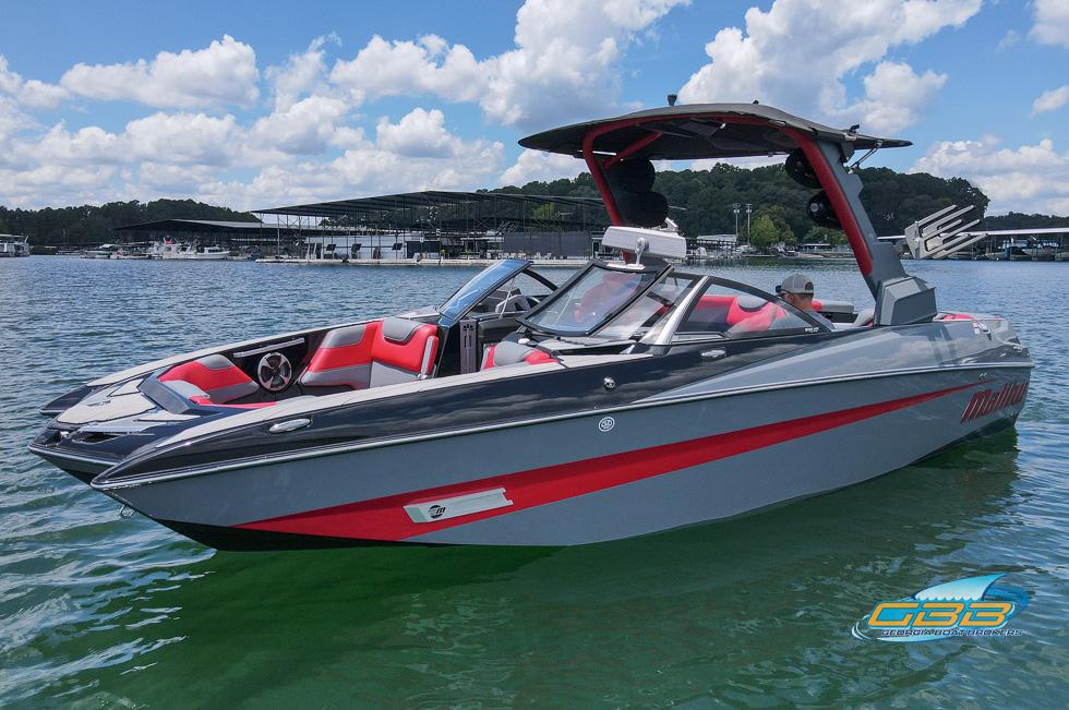 Malibu M235 2019 Malibu M235 boat on water, featuring sleek design and vibrant red accents.