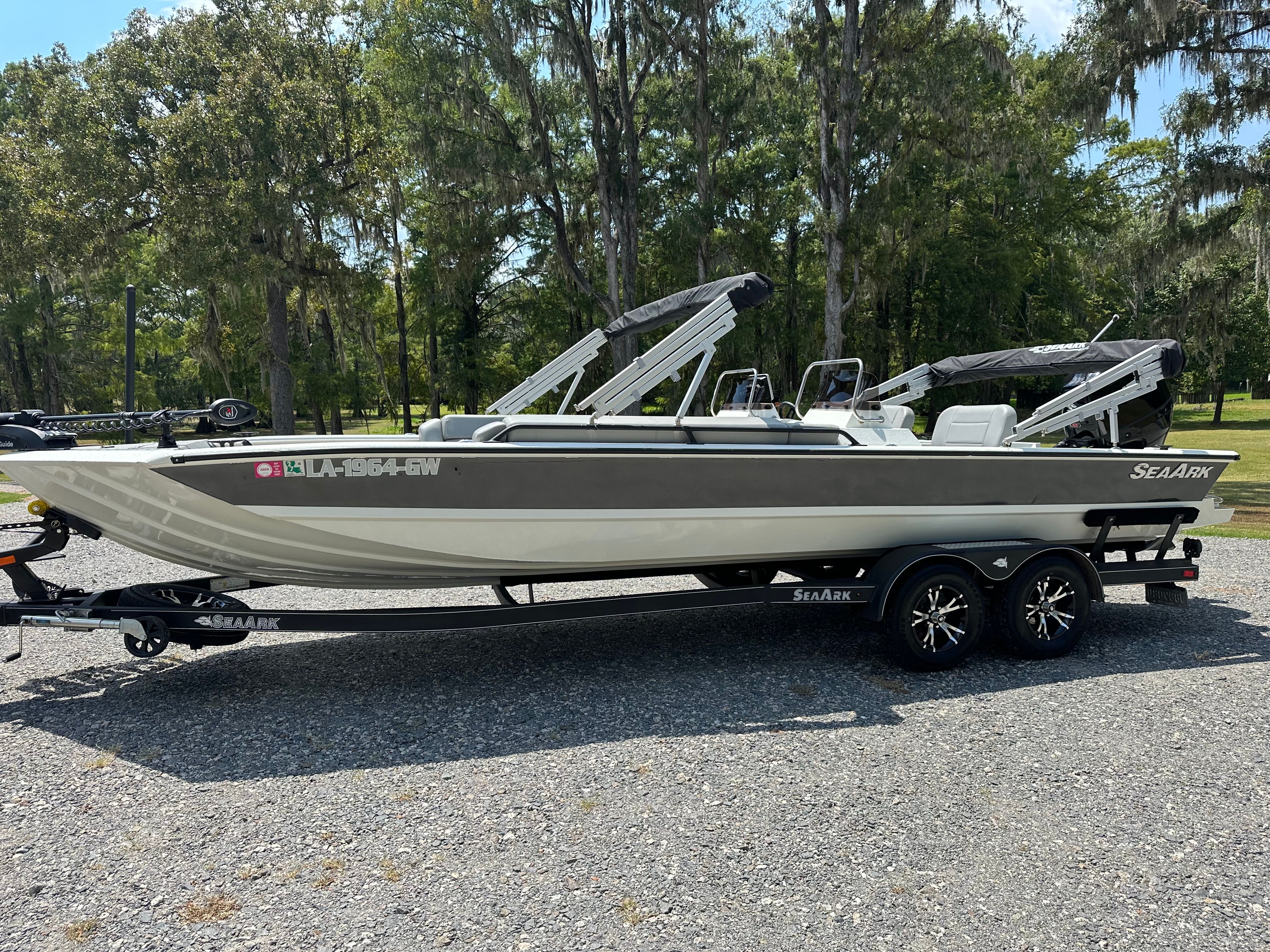 SeaArk Big Easy 2022 SeaArk Big Easy boat on trailer, parked outdoors with trees in background.