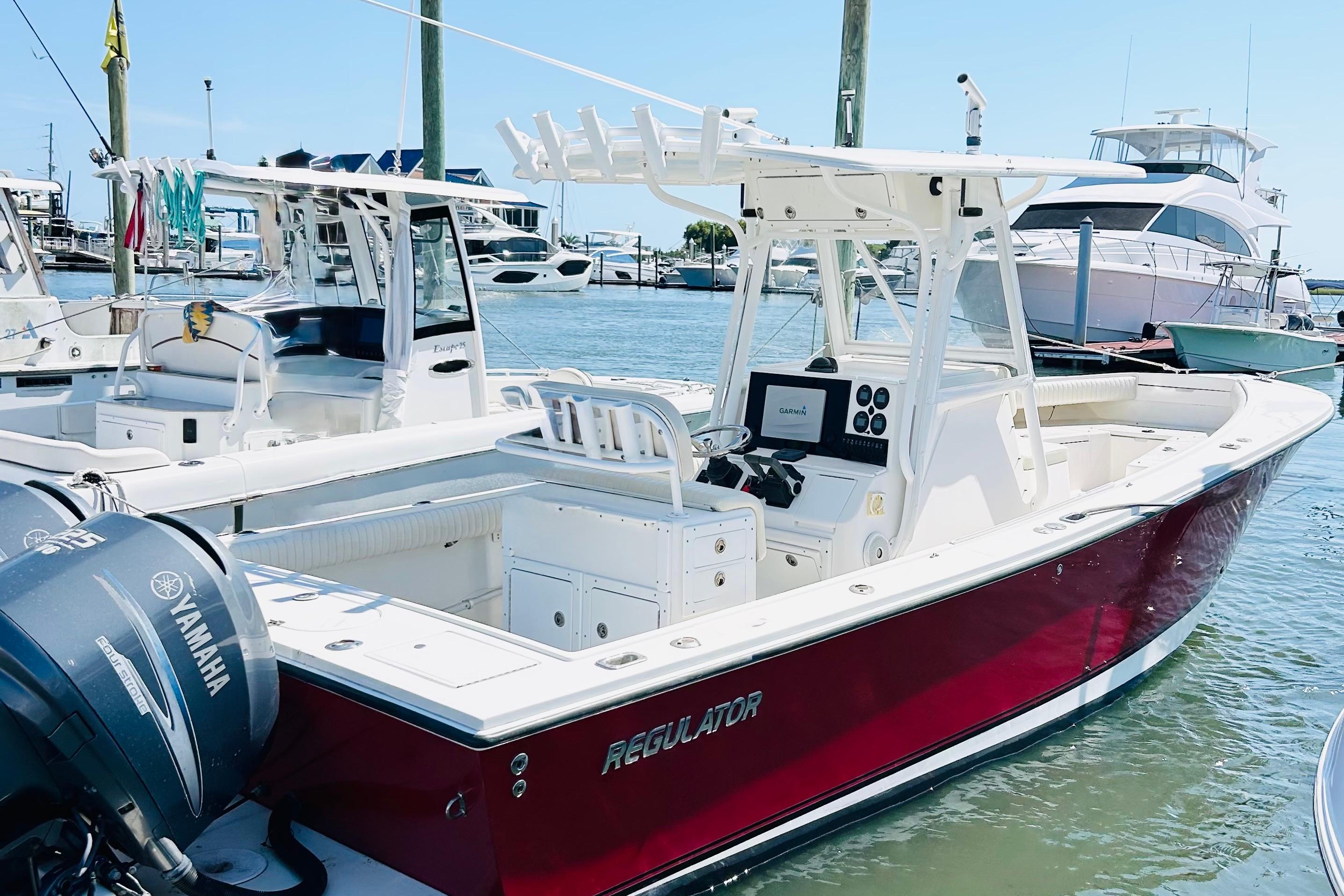 Regulator 26 Center Console 2003 Regulator 26 Center Console boat docked, featuring Yamaha outboard engines.