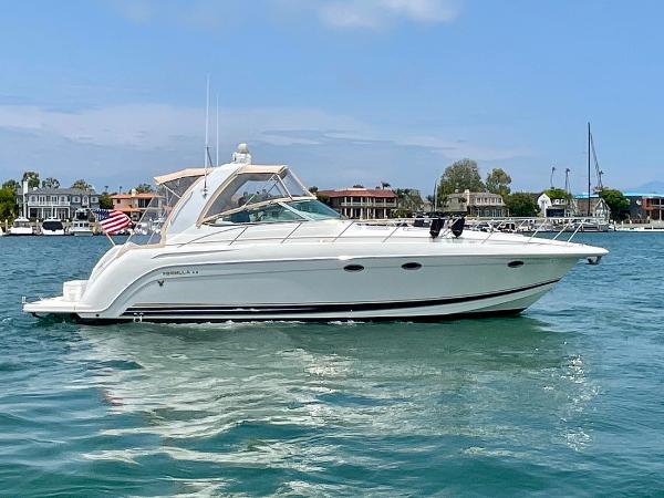 Formula 40 PC 2003 Formula 40 PC yacht cruising on a sunny day near waterfront homes.