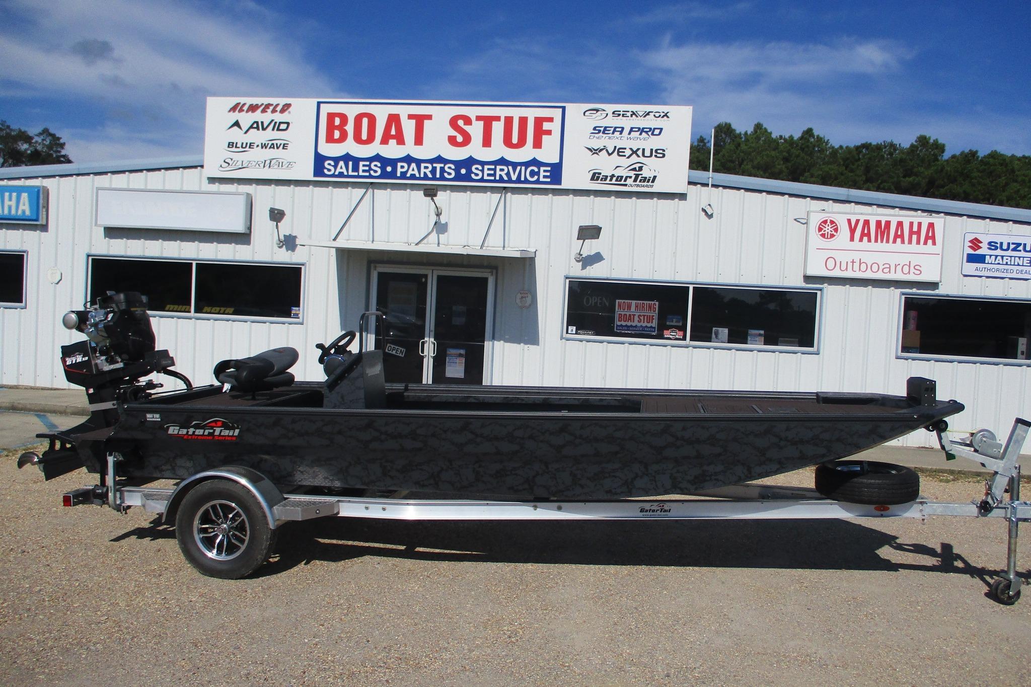 Gator-tail 2054 EXTREME CC 2026 Gator Tail 2054 EXTREME CC boat displayed outside dealership, featuring sleek design.