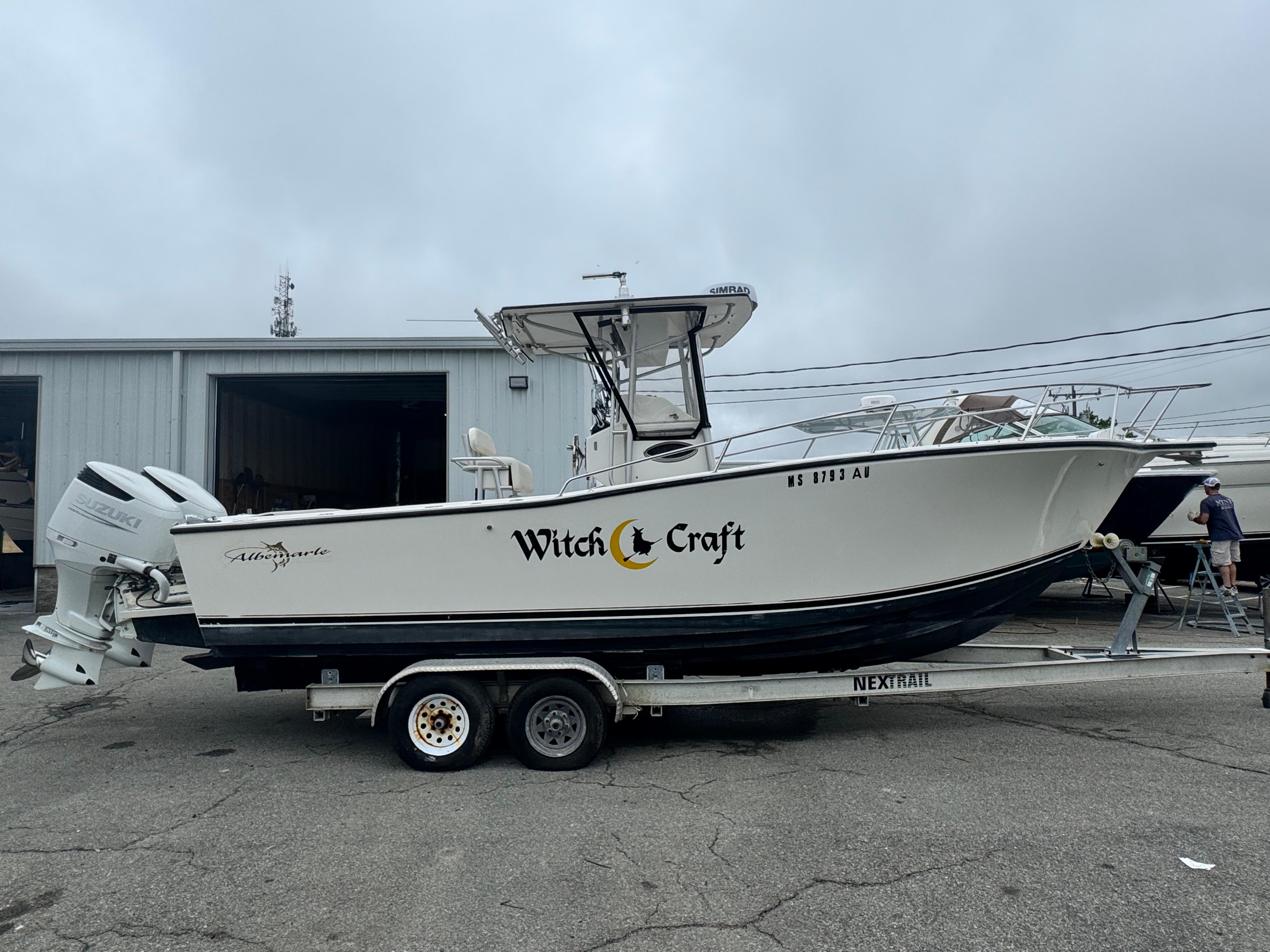 Albemarle 26 Cc 1995 Albemarle 26 CC boat named "Witch Craft" on a trailer, parked outside a building.