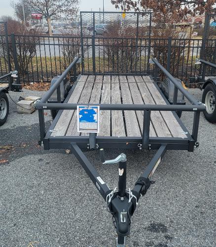 Tracker KTO-2990-60-10 (5X10) 2023 Tracker KTO-2990-60-10 utility trailer with wooden deck and metal frame.