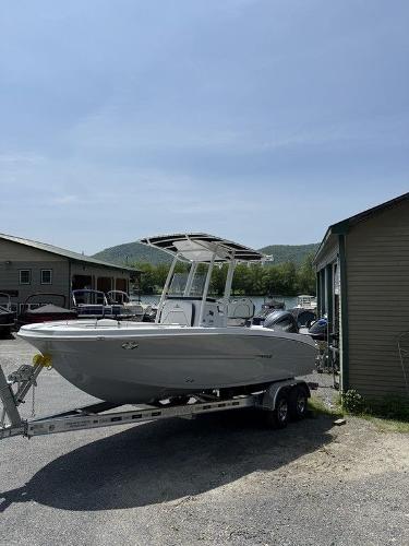 Stingray 216CC 2025 Stingray 216CC boat on trailer, parked outdoors near buildings under clear sky.