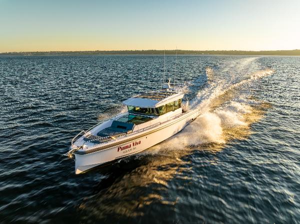 Axopar 37 XC Axopar 37 XC 2022 cruising on open water at sunset.