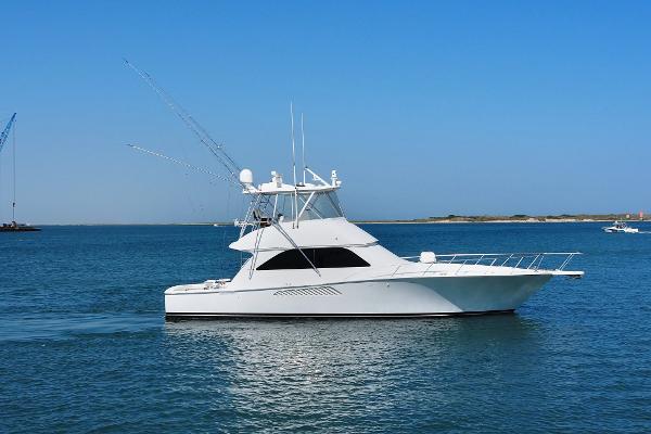 Viking Convertible 2007 Viking Convertible yacht with mezzanine cruising on calm blue waters.