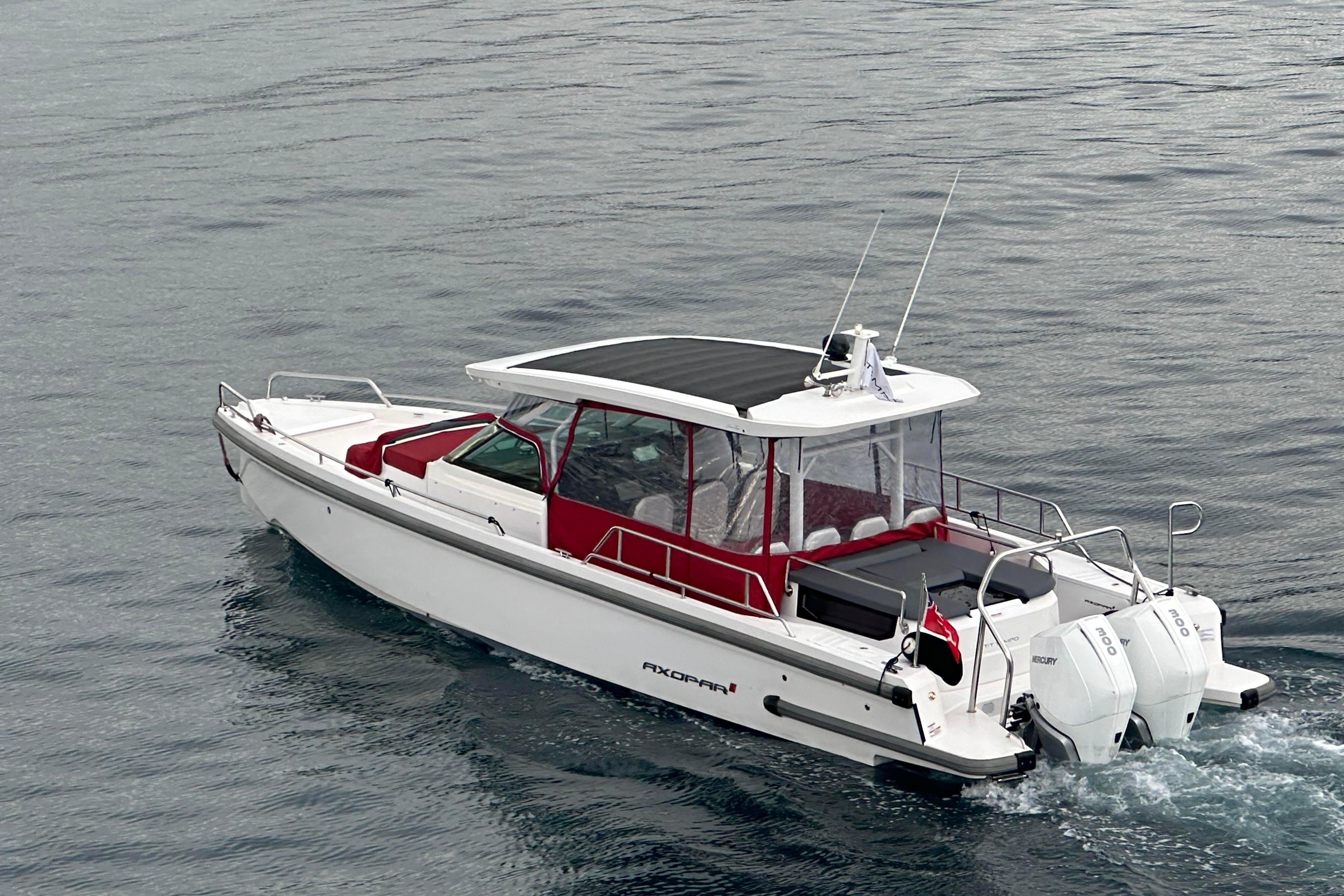 Axopar 37 Sun Top 2020 Axopar 37 Sun Top boat cruising on calm water, featuring sleek design and twin engines.