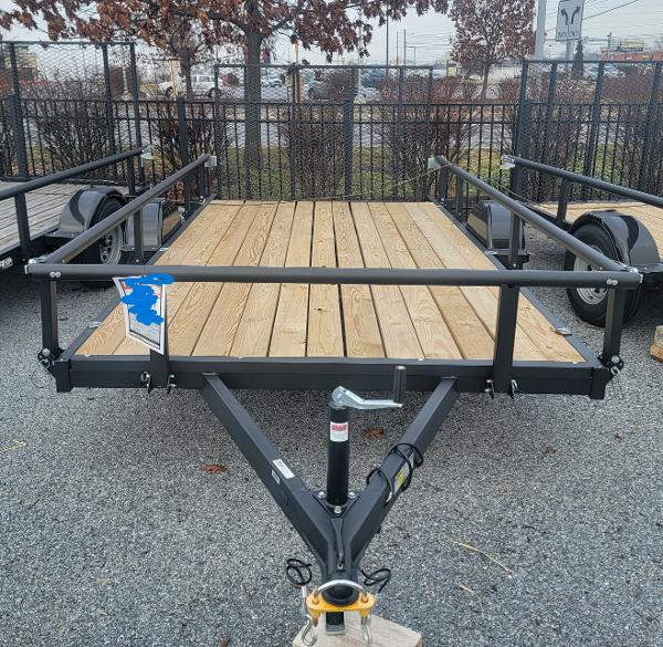 Tracker KTO-2990-82-13 (7X13) 2024 Tracker KTO-2990-82-13 utility trailer with wooden deck and metal frame.