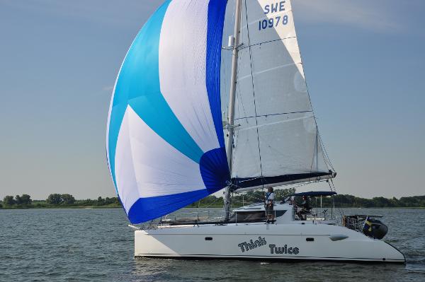 Fountaine Pajot Lavezzi Maestro 2005 Fountaine Pajot Lavezzi Maestro catamaran sailing with blue and white spinnaker.