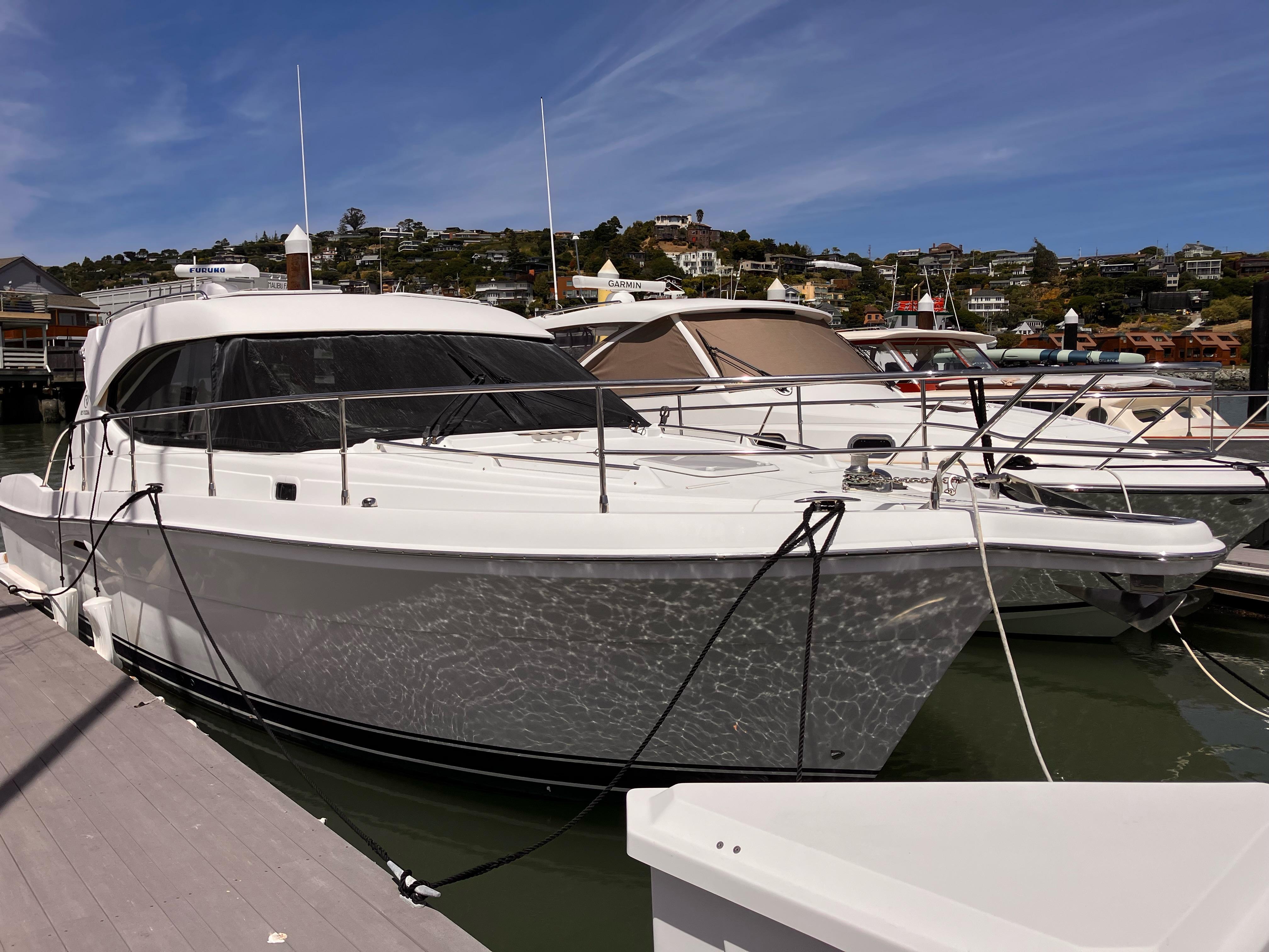 Riviera 3600 Sport Yacht 2007 Riviera 3600 Sport Yacht docked at marina under clear blue sky.