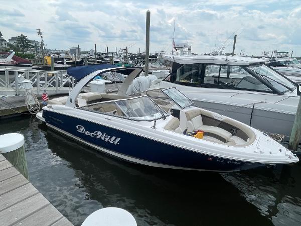 Regal 2700 Bowrider 2014 Regal 2700 Bowrider boat docked at marina, blue and white exterior.