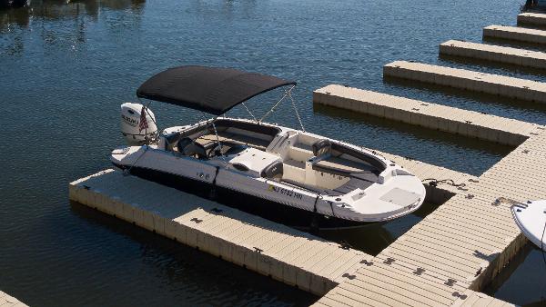 Stingray 212 SC 2019 Stingray 212 SC boat docked on calm water with canopy.