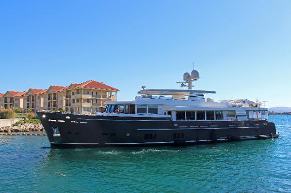 Van der Valk Explorer 37M 2026 Van der Valk Explorer 37M luxury yacht cruising near waterfront homes.