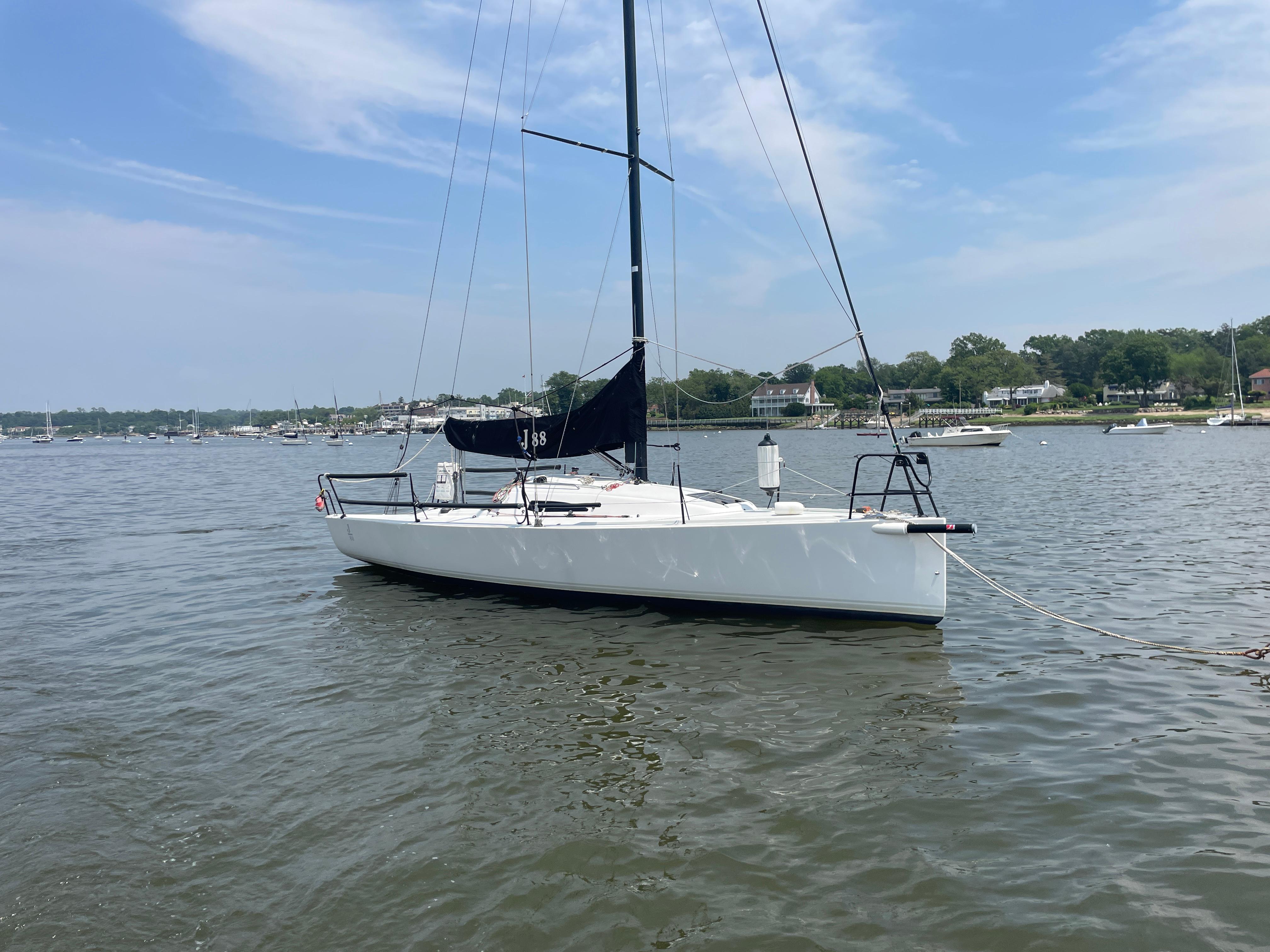 J Boats J/88 2014 J Boats J 88 sailboat anchored on calm water under a clear sky.
