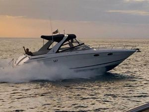 Regal 3350 Sport Cruiser 2011 Regal 3350 boat cruising on the water at sunset.