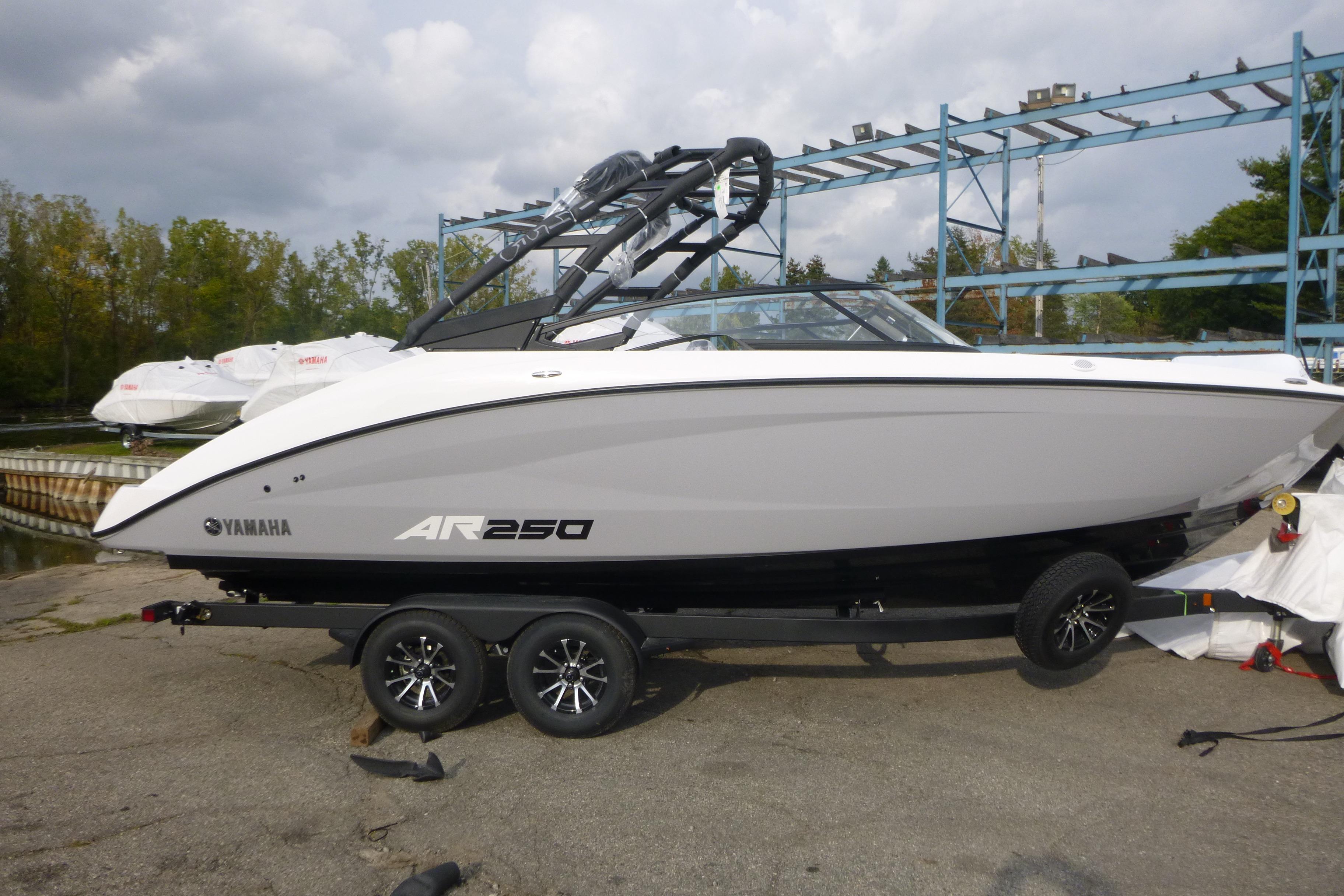 Yamaha Boats AR250 2026 Yamaha Boats AR250 on trailer, parked outdoors under cloudy sky.