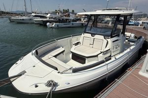 Jeanneau CAP CAMARAT 10.5 CC 2023 Jeanneau CAP CAMARAT 10.5 CC boat docked in a marina, showcasing sleek design.