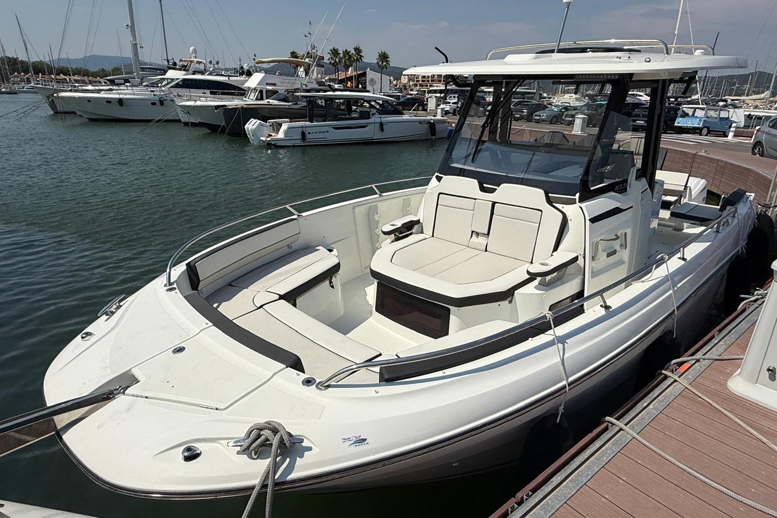 Jeanneau CAP CAMARAT 10.5 CC 2023 Jeanneau CAP CAMARAT 10.5 CC boat docked in a marina, showcasing sleek design.