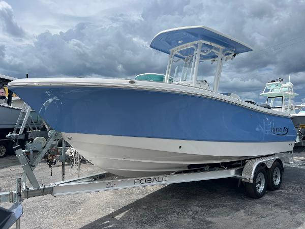 Robalo R230 Center Console 2024 Robalo R230 Center Console boat on a trailer under cloudy skies.