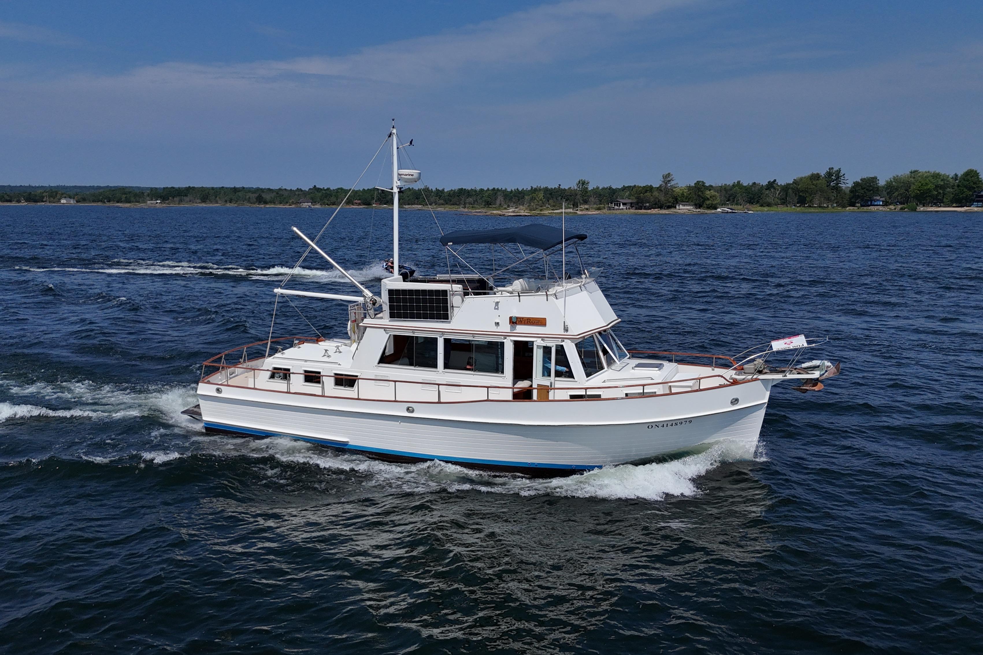 Grand Banks 42 Classic 1990 Grand Banks 42 Classic yacht cruising on open water under clear skies.