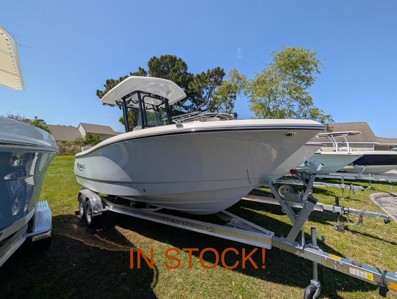Robalo R232 Explorer 2025 Robalo R232 Explorer boat on trailer, in stock, sunny day.