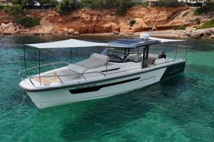 Nimbus T 11 - lake constance registration 2023 Nimbus T 11 boat on clear turquoise water near rocky shoreline.