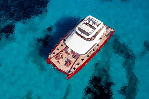 Lagoon SIXTY 7 Aerial view of 2025 Lagoon SIXTY 7 yacht on clear blue water.