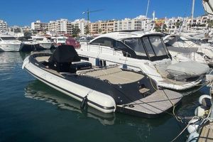 Scanner Envy 950 Touring 2021 Scanner Envy 950 Touring boat docked in a marina, surrounded by other yachts.