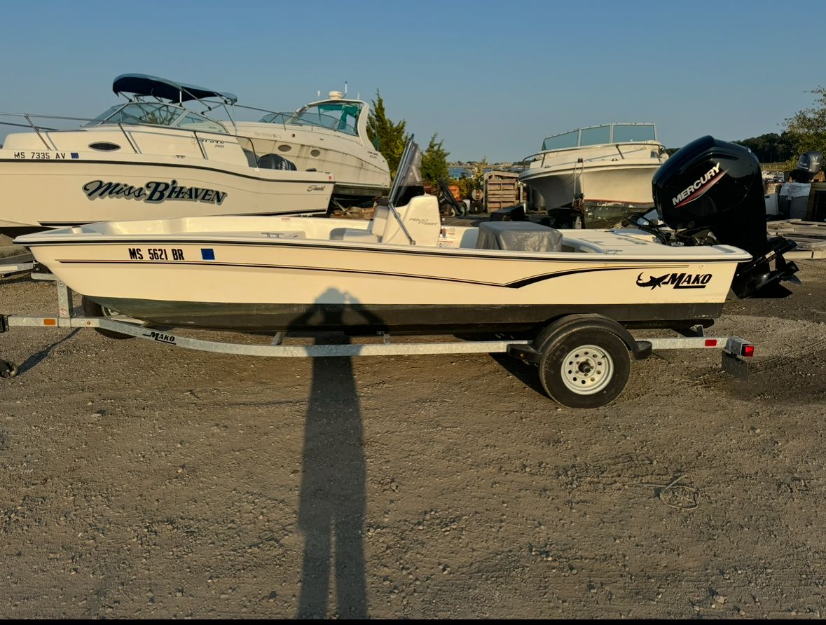 Mako Pro Skiff 17 CC 2022 Mako Pro Skiff 17 CC on trailer, parked near other boats.
