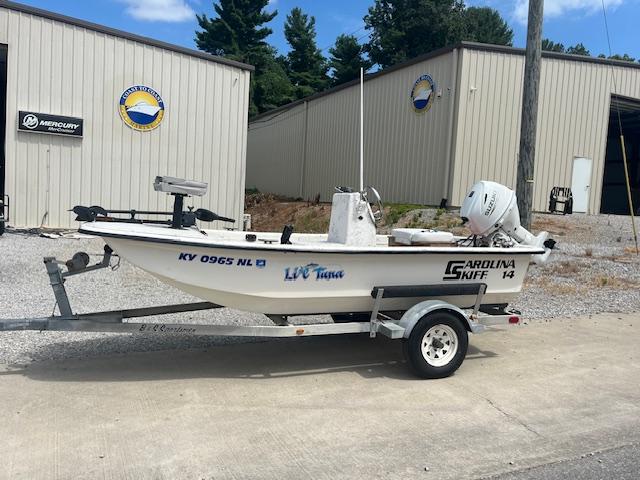 Carolina Skiff J1450 2000 Carolina Skiff J1450 boat on trailer, parked outside a warehouse.