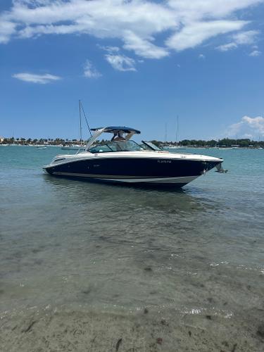 Sea Ray 270 SLX 2014 Sea Ray 270 SLX boat on calm water under a clear blue sky.