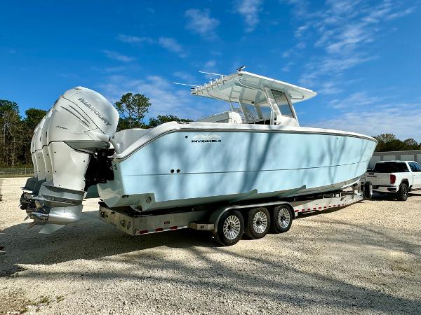 Invincible 37 Catamaran 2020 Invincible 37 Catamaran on trailer, light blue hull, dual outboard engines, parked outdoors.
