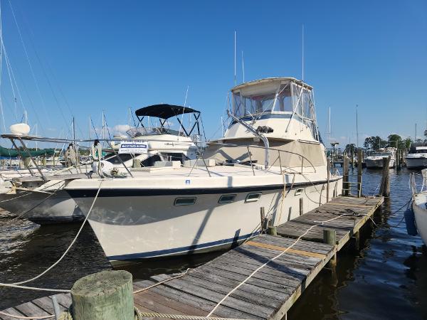 Hatteras Sport Fisher 1968 Hatteras Sport Fisher boat docked at a marina on a sunny day.