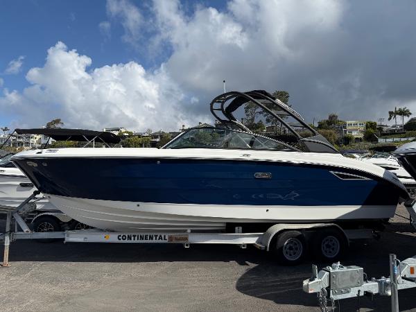Sea Ray SDX 270 2025 Sea Ray SDX 270 boat on trailer under cloudy sky.