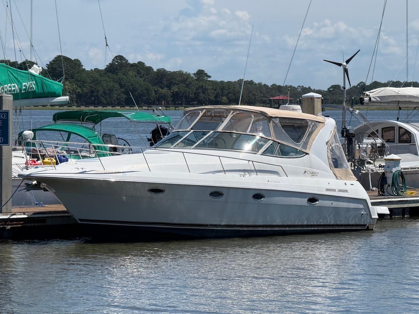 Cruisers Yachts 3375 Express 2000 Cruisers Yachts 3375 Express docked at marina, sunny day, calm water.