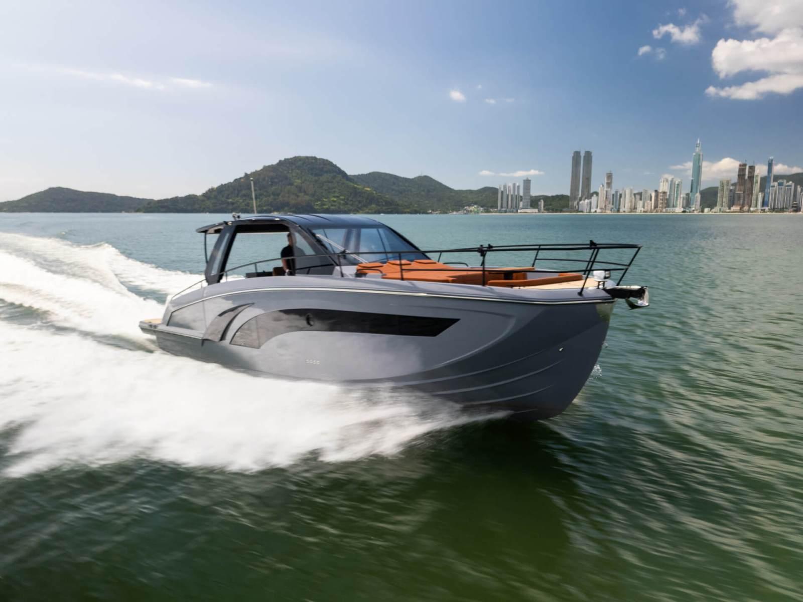 Hanover 447 Inboard 2025 Hanover 447 Inboard cruising on water near city skyline and mountains.
