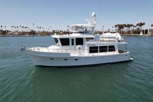 Symbol 45 White Symbol 45 yacht from 2004 on calm water, with palm trees in the background.
