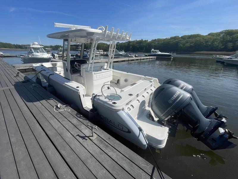 Robalo R270 Center Console 2023 Robalo R270 Center Console boat docked with twin Yamaha engines.