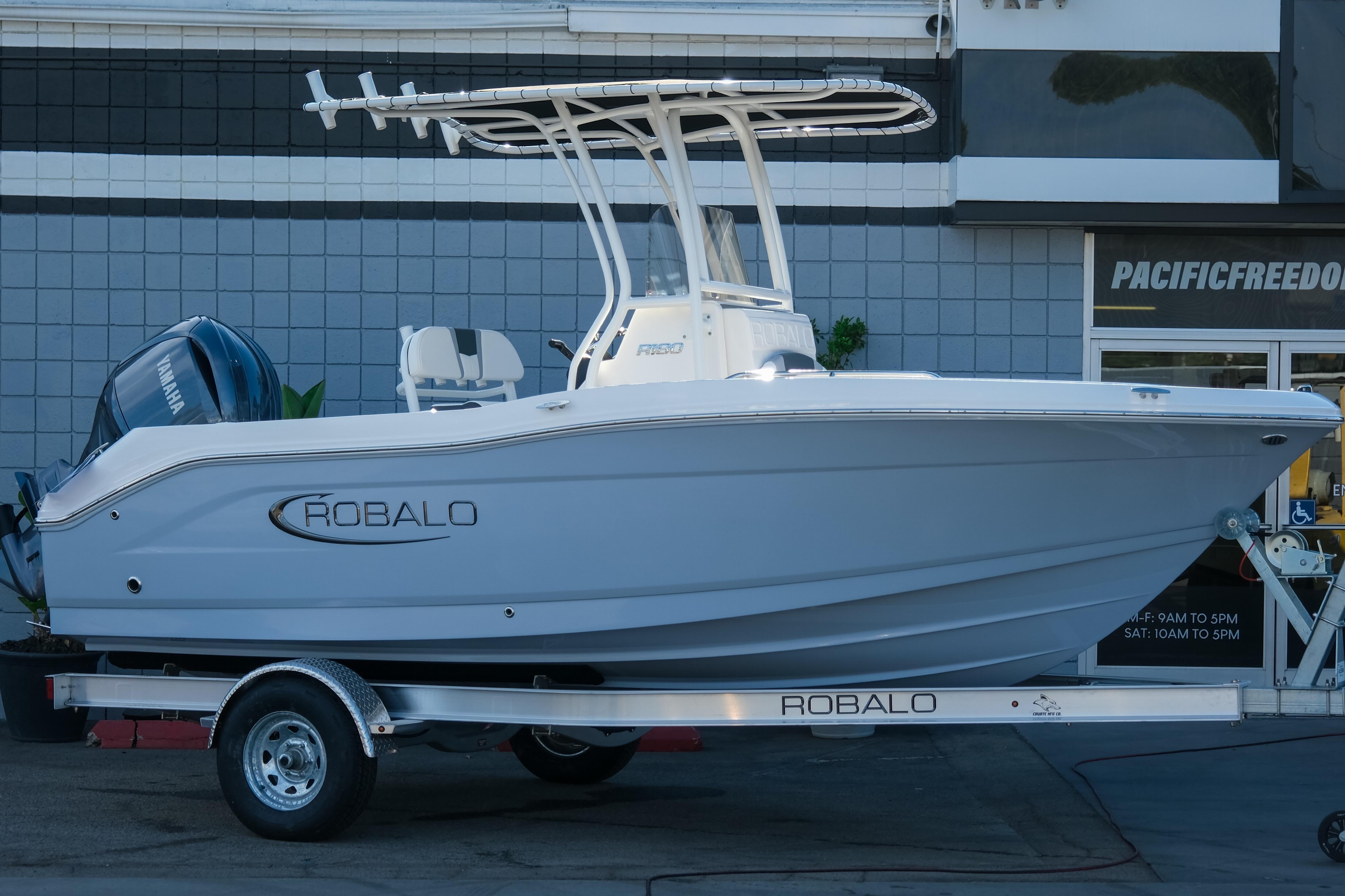 Robalo R180 Center Console 2025 Robalo R180 Center Console boat on trailer, displayed outdoors.