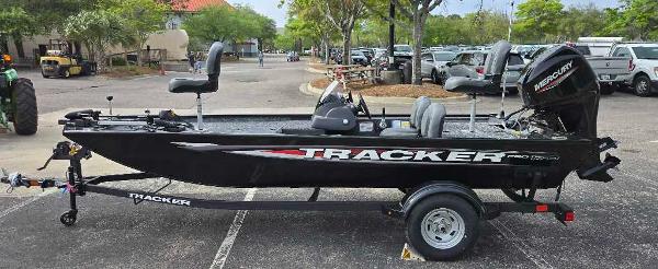Tracker Pro 170 2025 Tracker Pro 170 boat on trailer in parking lot, side view.