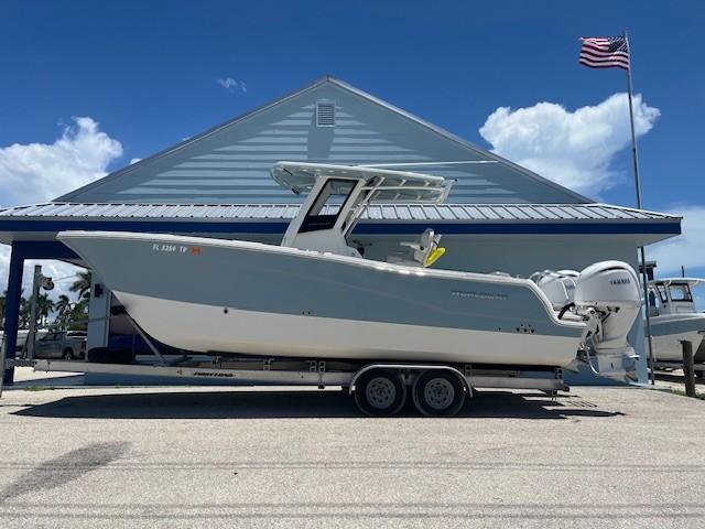 World Cat 260 CC-X 2024 World Cat 260 CC-X boat on trailer, parked near a building with an American flag.