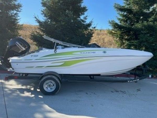 Tahoe T18 2024 Tahoe T18 boat on trailer, white with green accents, parked outdoors.
