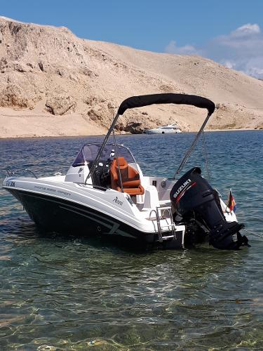 Custom Prins 555 Open 2016 Custom Prins 555 Open boat in clear water near rocky shore.