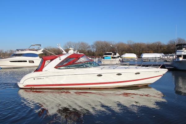 Formula 400 Super Sport 2001 Formula 400 Super Sport boat docked in a marina, featuring a sleek white and red design.