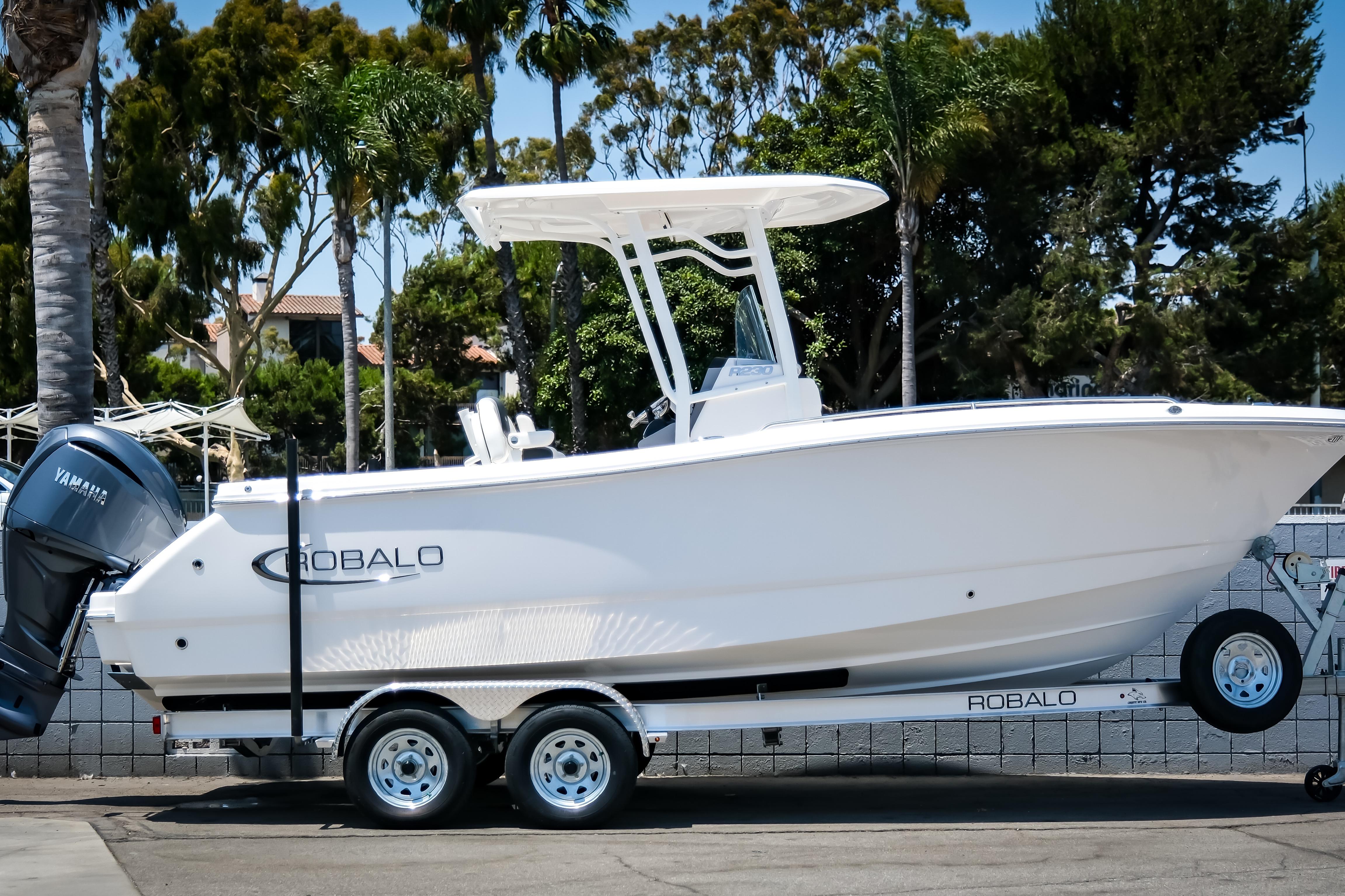 Robalo R230 Center Console 2025 Robalo R230 Center Console boat on trailer, parked outdoors.