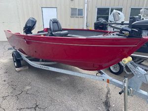 Lund 1650 Angler Tiller 2023 Lund 1650 Angler Tiller boat in red on a trailer.